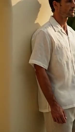 A cream short-sleeve camp shirt worn against a plaster wall, then outside in daylight.